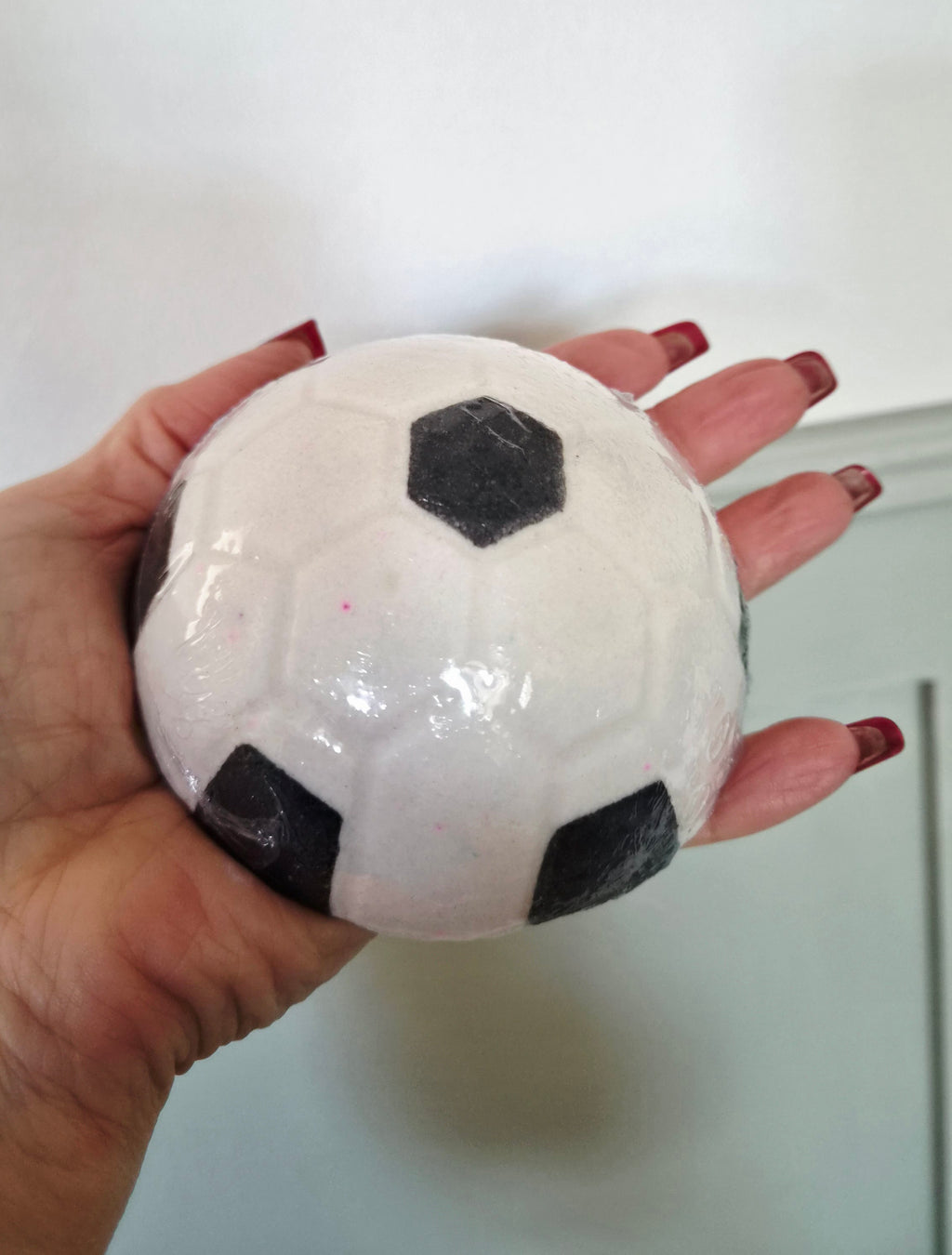 Football Bath bomb in strawberry scent.