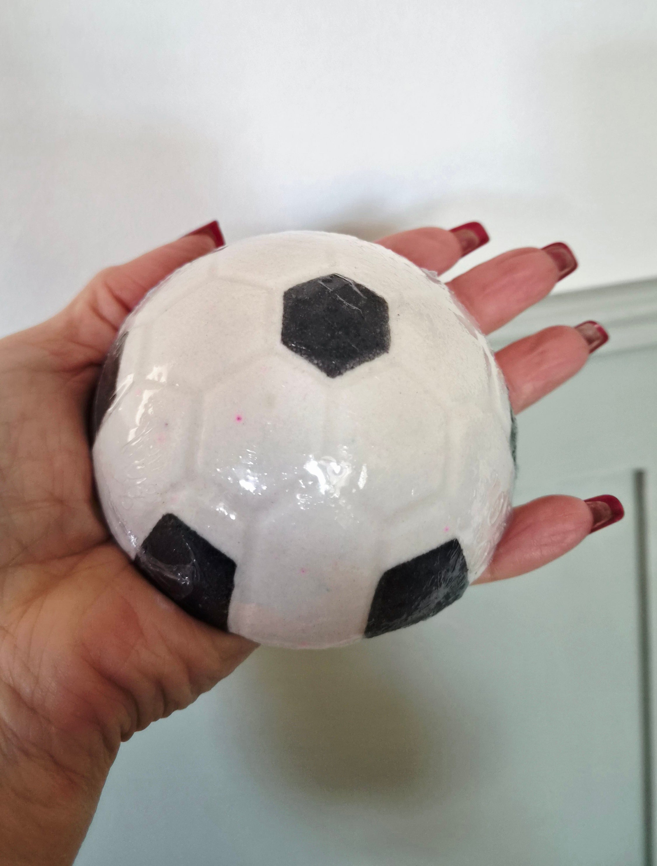 Football Bath bomb in strawberry scent.